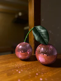 two disco balls on top of a wooden table