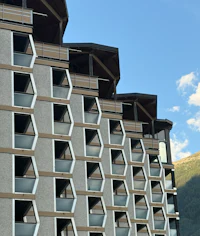 a building with balconies and balconies in the mountains